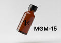Brown bottle with black cap and 'MGM-15' text on a light gray background